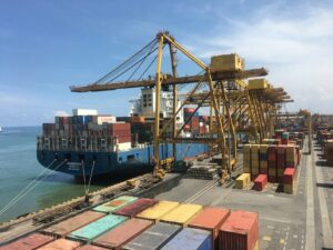 Container ship at a working port terminal handling ocean freight from China to Australia