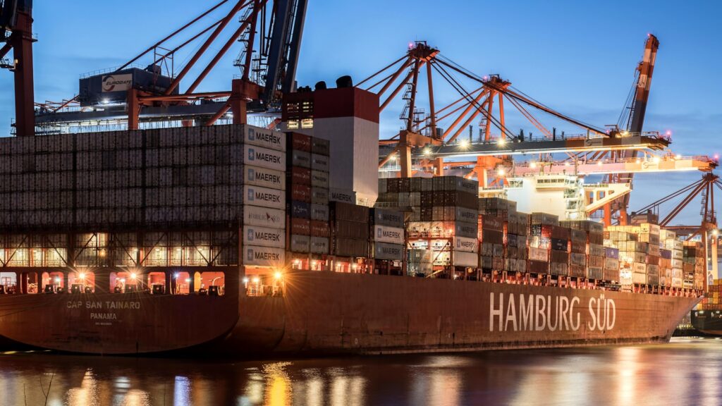 Container ship docked at the Port of Hamburg terminal at dusk