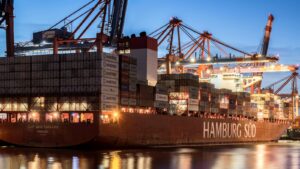 Container ship docked at the Port of Hamburg terminal at dusk