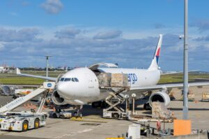 Cargo freighter being loaded on the tarmac for air shipping from the USA to France