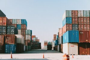 Ground-level aisle between stacks of shipping containers in a container yard