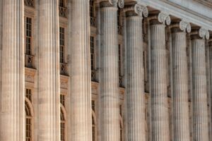 Row of fluted stone columns along the facade of a neoclassical courthouse-style building