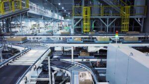 Small parcels and cartons moving on automated conveyors through a parcel sorting hub