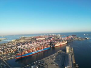 Aerial view of the Port of Long Beach with large container ships at berth along the terminals