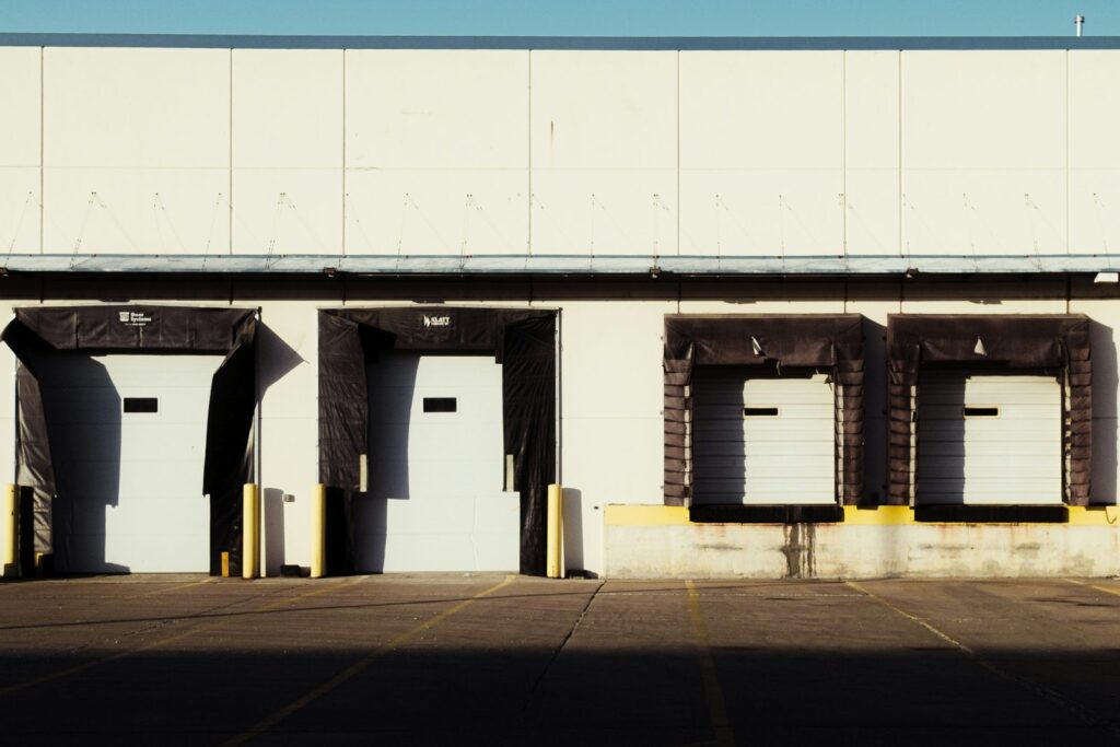 Row of warehouse loading dock doors with dock seals at a distribution building